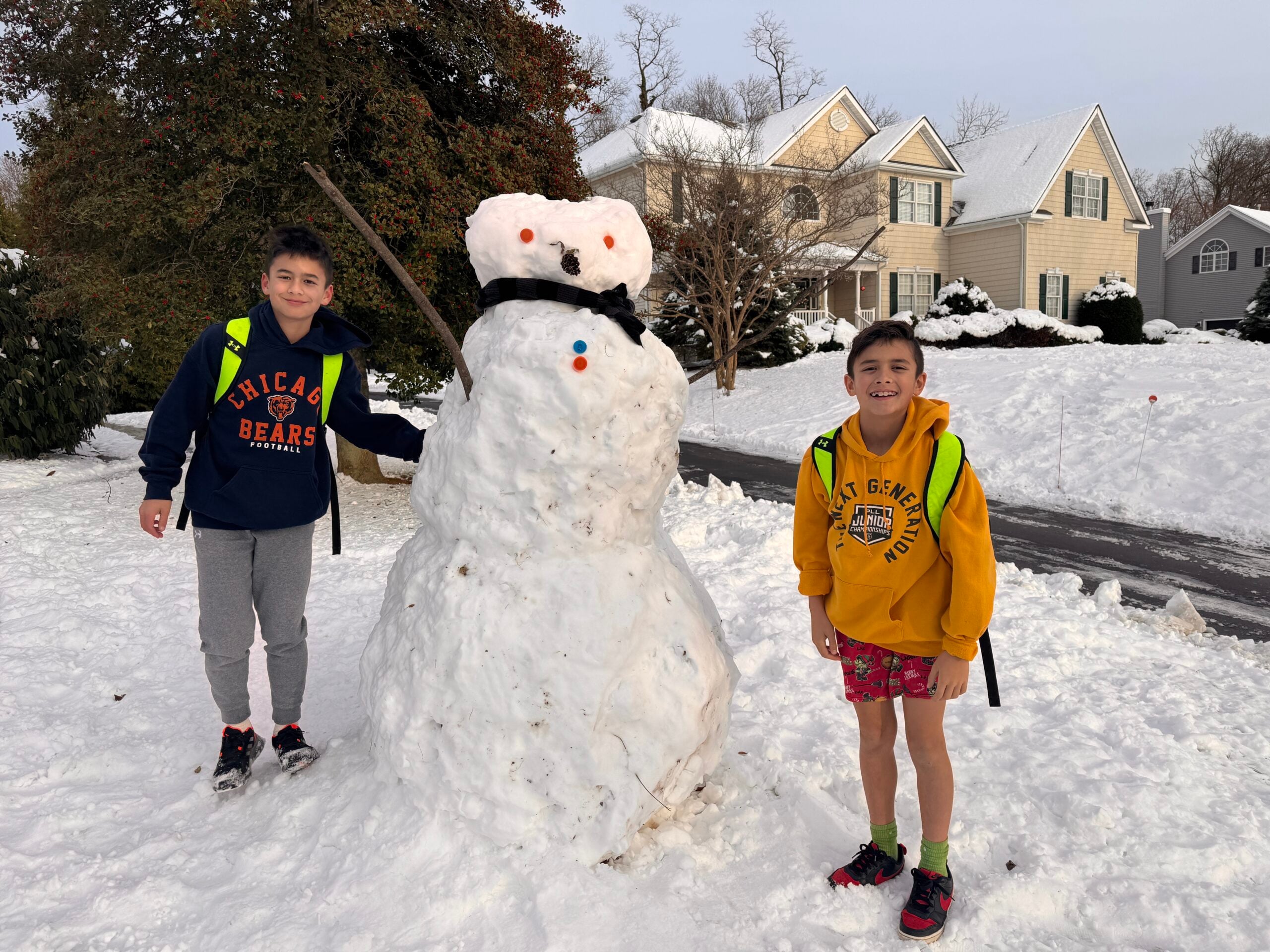 Connor and Preson Lunn and their snowman on South Street 12152025